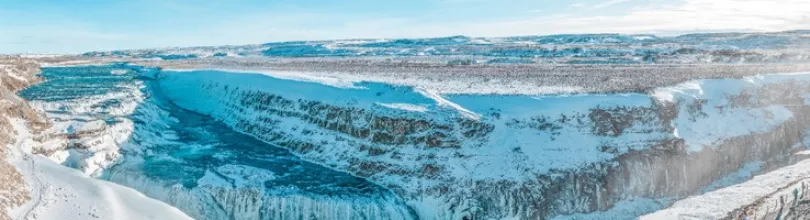 Gullfoss waterfall in a snow-covered landscape.