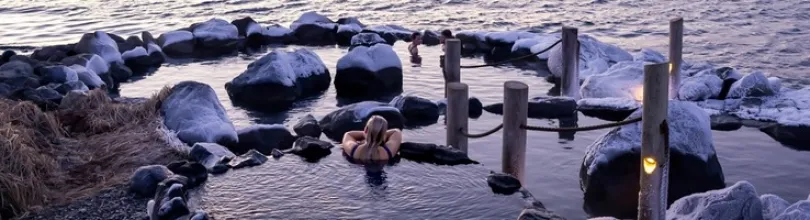 Guests bathing at Hvammsvík Hot Springs.