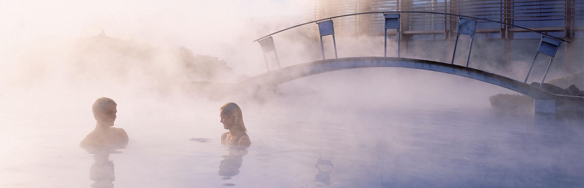 Iceland spa break at Blue Lagoon spa: couple bathing at spa Blue Lagoon, south of Iceland.