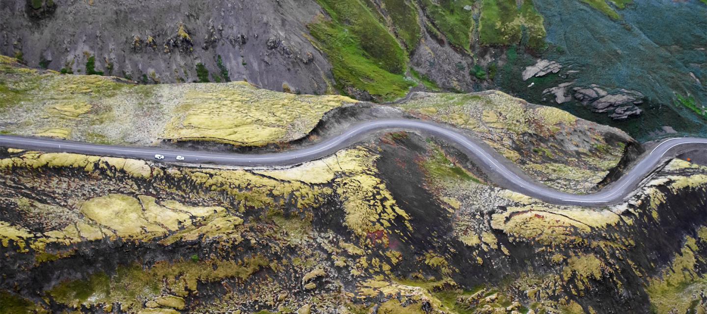 Driving rental car in Iceland: Aerial view of curvy road in Iceland.